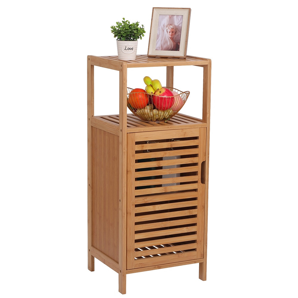 Wooden bamboo bathroom cabinet with slatted door and open shelf on top, fruit bowl and decorative items